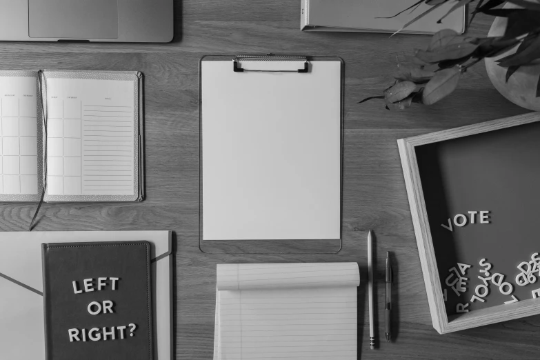 a laptop computer sitting on top of a wooden desk, a black and white photo, by Karl Buesgen, pexels contest winner, academic art, clipboard, knolling, background image