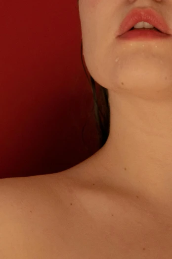 a woman holding a pair of scissors in front of her face, an album cover, inspired by Elsa Bleda, trending on pexels, hyperrealism, red birthmark, on a young beautiful woman neck, on a red background, soft portrait shot 8 k