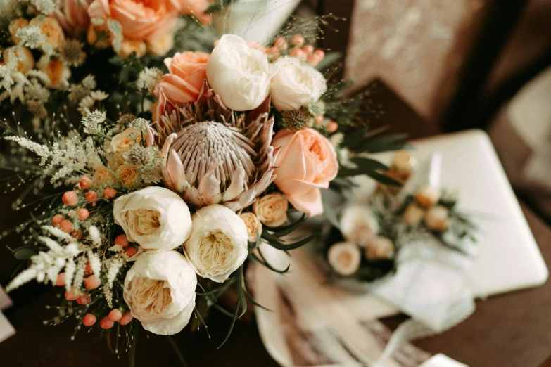 a bunch of flowers sitting on top of a table, by Carey Morris, trending on unsplash, romanticism, ivory and copper, patterned, closeup - view, bouquets