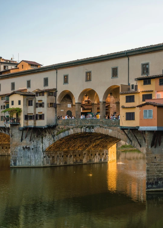 a group of people walking across a bridge over a river, by Carlo Martini, pexels contest winner, renaissance, sweeping arches, late summer evening, square, van