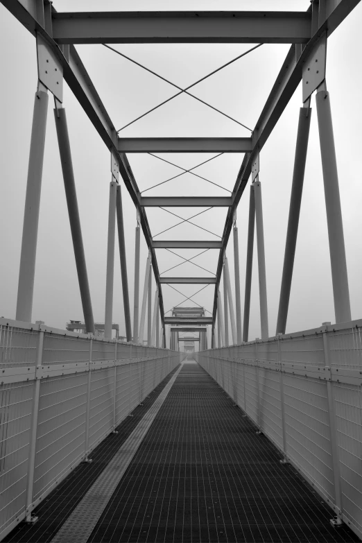 a black and white photo of a bridge, inspired by Thomas Häfner, steel and metal, walking towards camera, square lines, [ realistic photography ]