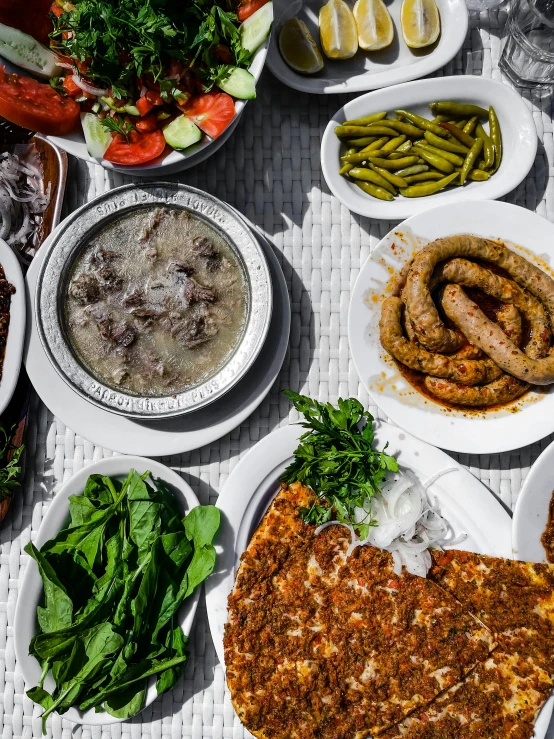 a number of plates of food on a table, a photo, pexels contest winner, dau-al-set, turkish and russian, thumbnail, exterior shot, grayish