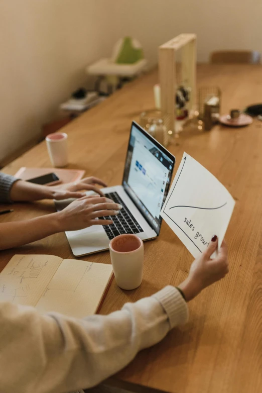 a couple of people sitting at a table with laptops, a drawing, trending on pexels, cardboard, elegant design, thumbnail, opening shot