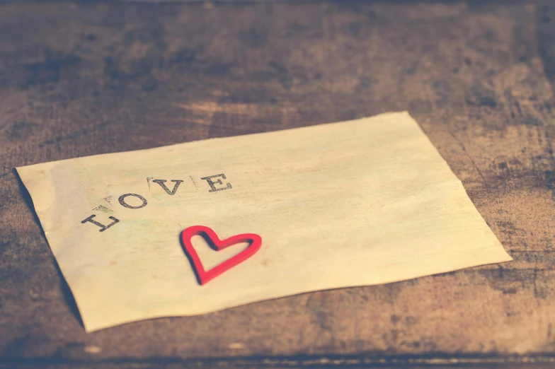 a piece of paper with a red heart on it, a picture, hope, canva, toned paper, with some hand written letters