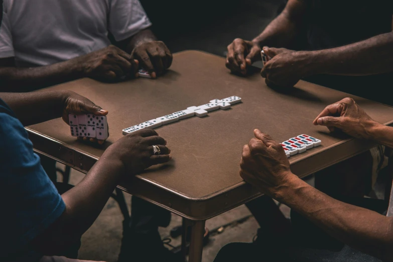 a group of people sitting around a table playing cards, an album cover, by Carey Morris, pexels contest winner, dark-skinned, symmetrical hands, 15081959 21121991 01012000 4k, thumbnail