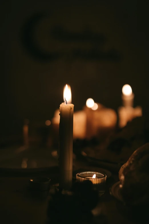 a group of lit candles sitting on top of a table, profile image, muted lighting, instagram photo, ignant