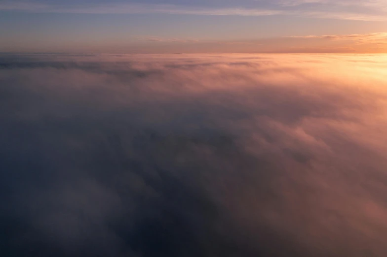 a plane is flying high above the clouds, by Daniel Lieske, pexels contest winner, romanticism, foggy sunset, heaven pink, view from helicopter, layered stratocumulus clouds
