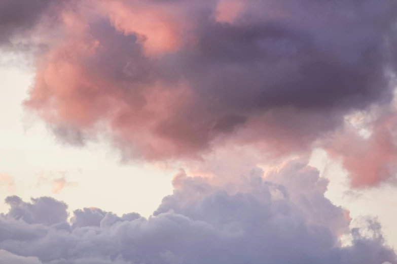 a couple of cows standing on top of a lush green field, unsplash, romanticism, pink storm clouds, layered stratocumulus clouds, atmospheric photo, pink and purple
