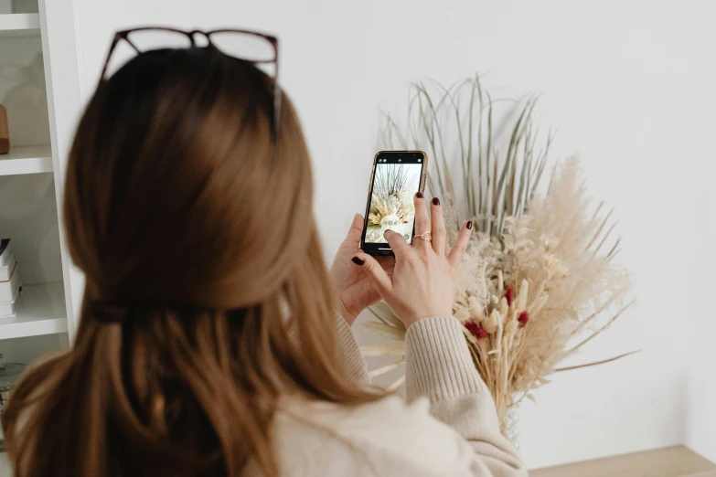 a woman taking a picture with her cell phone, trending on pexels, visual art, modern earthy neutral earthy, miniature product photo, flowers around, avatar image