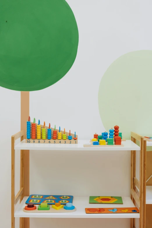 a child's play room with a green tree on the wall, inspired by Frederick Hammersley, trending on unsplash, visual art, detail shot, tables, mathematical, wooden art toys on base