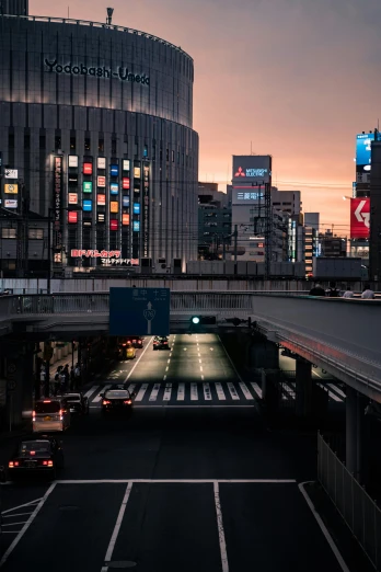 a city street filled with lots of traffic next to tall buildings, unsplash contest winner, ukiyo-e, last light, overpass, brutalist shiro, empty streetscapes