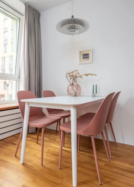 a dining room with a white table and pink chairs, by Zofia Stryjenska, pexels contest winner, modernism, city apartment cozy calm, warsaw, profile image, fan favorite