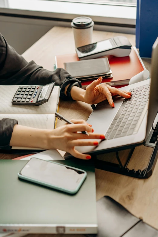 a woman sitting at a desk using a laptop computer, trending on pexels, mathematical, bottom angle, low quality photo, thumbnail