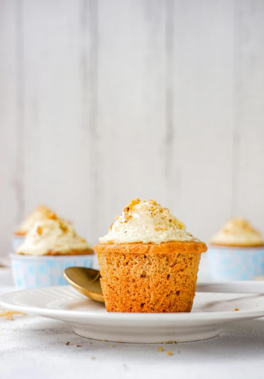 a cupcake sitting on top of a white plate, thumbnail, listing image, square, blonde cream