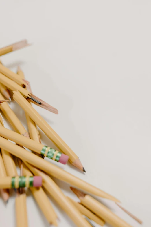 a pile of pencils sitting on top of a table, by Nicolette Macnamara, trending on pexels, beige sky pencil marks, performance, a high angle shot, multiple stories