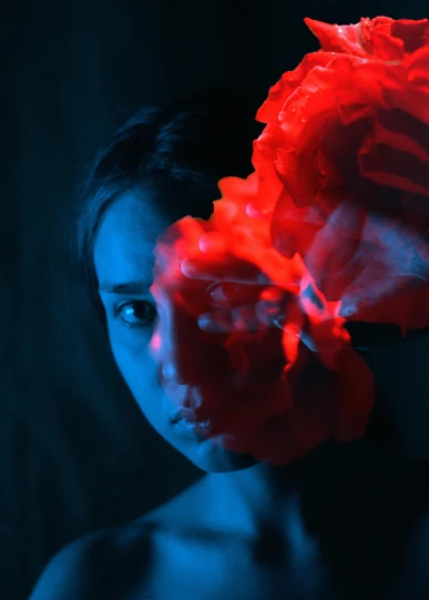a woman with a red flower in her hair, pexels contest winner, art photography, with blue light inside, an film still, avatar image, concept photo