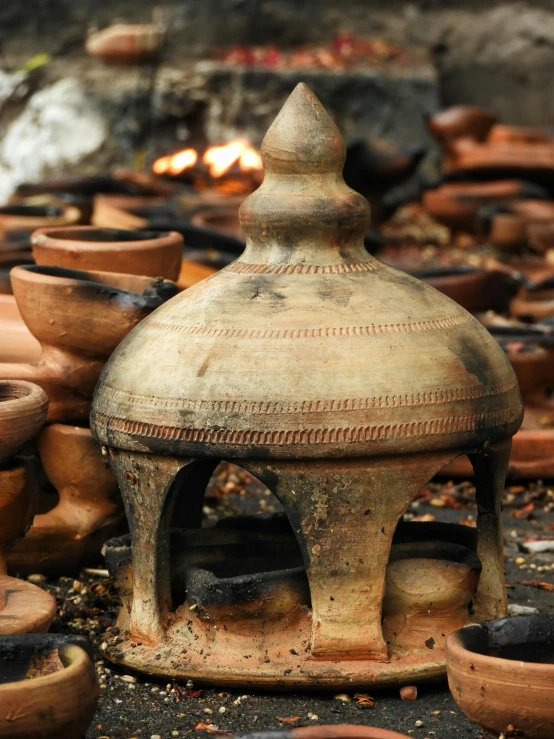 a group of clay pots sitting next to each other, burning, intricate ornament, thumbnail, restored