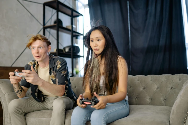 a man and a woman sitting on a couch playing video games, pexels, realism, jordan grimmer and natasha tan, linus from linustechtips, ceo of microsoft gaming ( xbox ), an asian woman