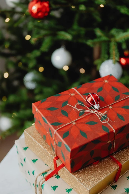 presents stacked on top of each other in front of a christmas tree, profile image, multiple stories, medium close up, tag