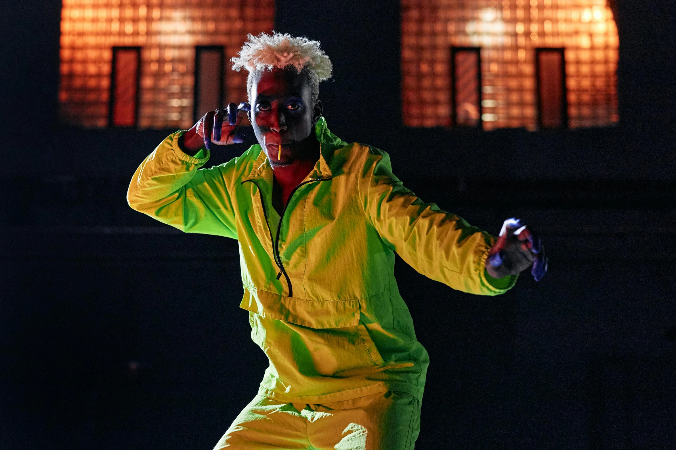a man dressed as a clown doing tricks on a skateboard, an album cover, pexels, afrofuturism, yellow spiky hair, performing on stage, chappie in an adidas track suit, avatar image
