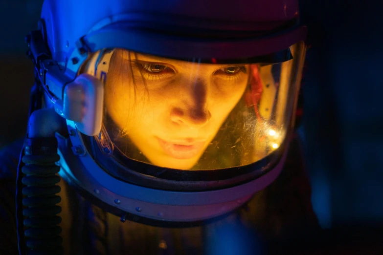 a close up of a person wearing a helmet, serial art, sandra bullock, in a space horror setting, aura jared and wires, amelie poulain