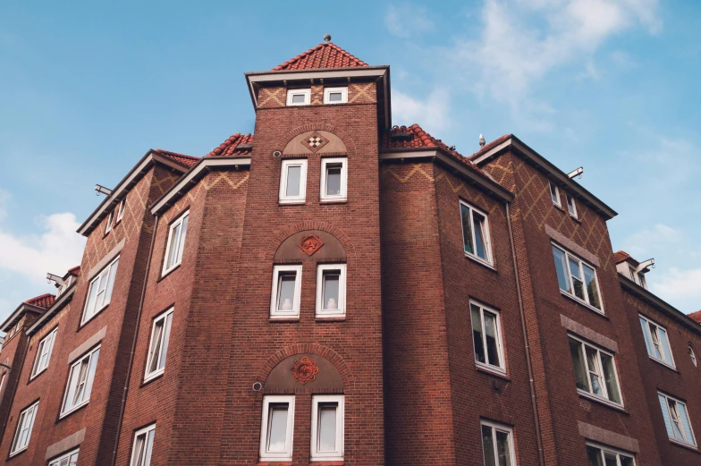 a tall brick building with a clock tower, by Kristian Zahrtmann, pexels contest winner, apartment complex made of tubes, brown, high forehead, 1 4 9 3