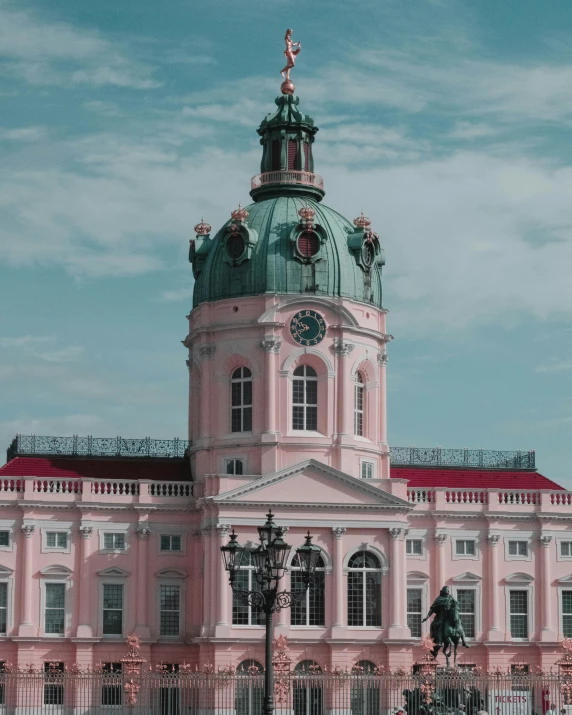 a large pink building with a green dome, a colorized photo, inspired by Adolf Born, pexels contest winner, baroque!, lgbt, germany, it has a red and black paint