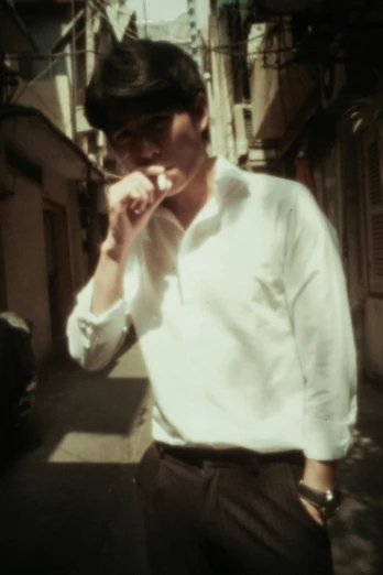 a man in a white shirt talking on a cell phone, an album cover, inspired by Gang Hui-an, dada, 4 k photo autochrome, smoking outside, beatle, leng jun