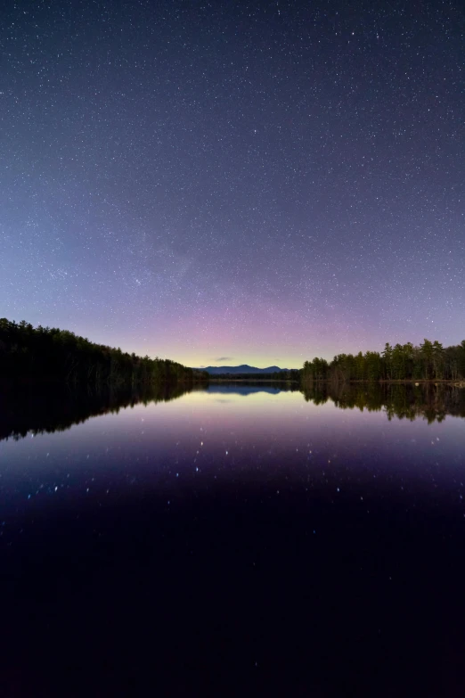 a lake in the middle of a forest at night, by David Michie, unsplash contest winner, hudson river school, purple omnious sky, new hampshire mountain, saturn and supermoon in the sky, visible planets in the sky