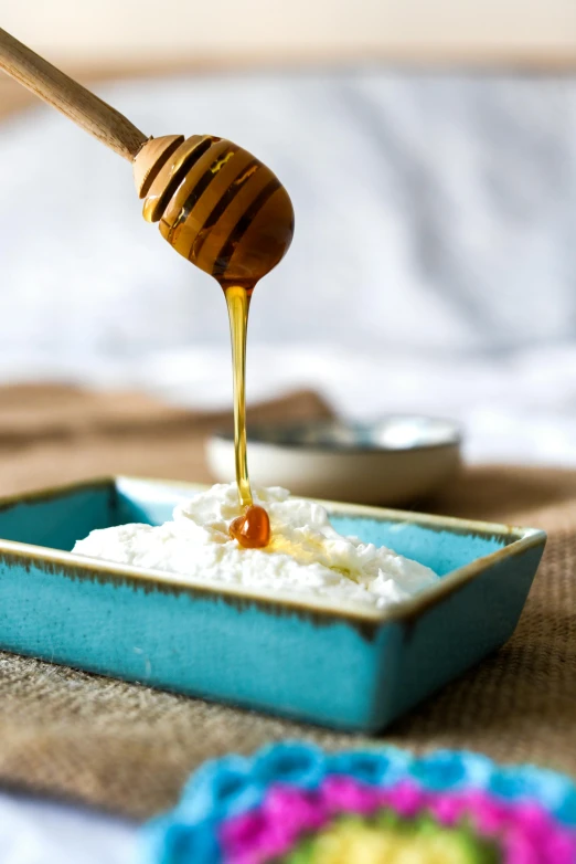 honey being drizzled over a bowl of yogurt, a portrait, inspired by Kanō Shōsenin, unsplash, sea foam, square, blue, linen