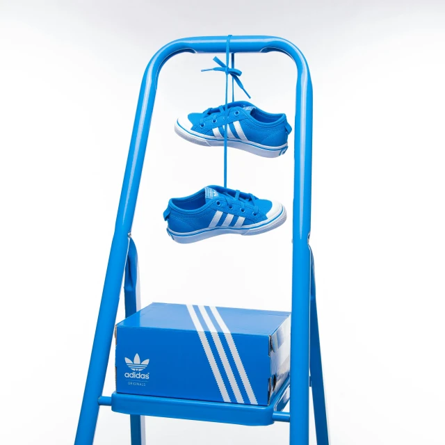 a shoe rack with three pairs of shoes on it, by Niels Lergaard, graffiti, new adidas logo design, bright blue, studio product shot, newton's cradle