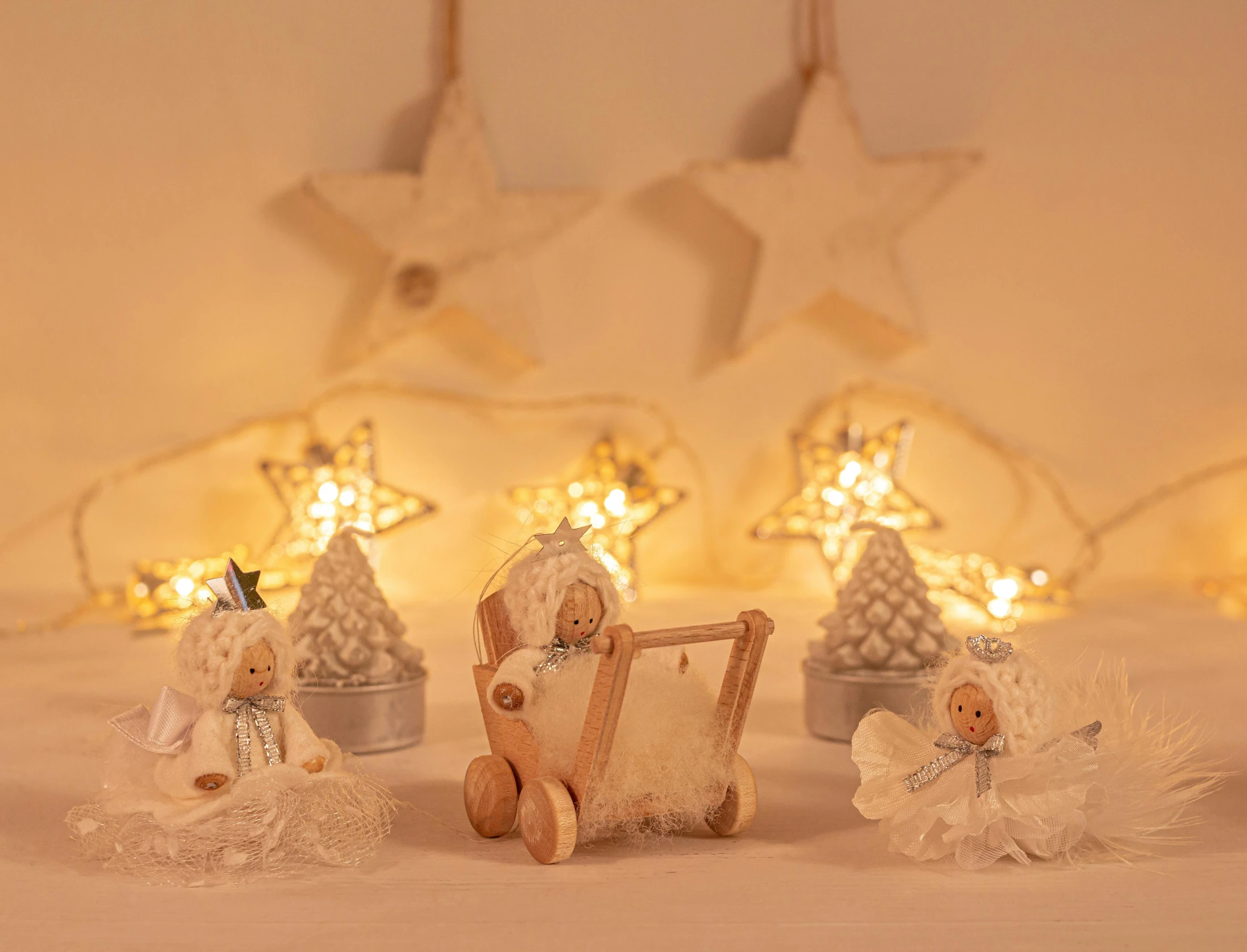 a group of christmas figurines sitting on top of a bed, a picture, by Sylvia Wishart, firefly lights, product introduction photo, carriage, white