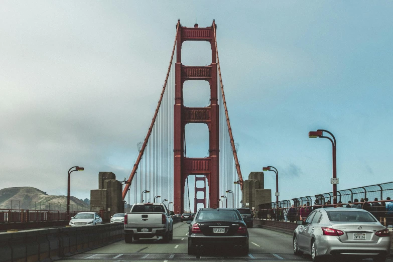 a group of cars driving across a bridge, by Carey Morris, pexels contest winner, renaissance, golden gate, 🚿🗝📝, giants, hyper realistic ”