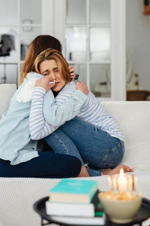 two women sitting on a couch hugging each other, incoherents, woman crying, what happens after death, instagram photo, medium-shot