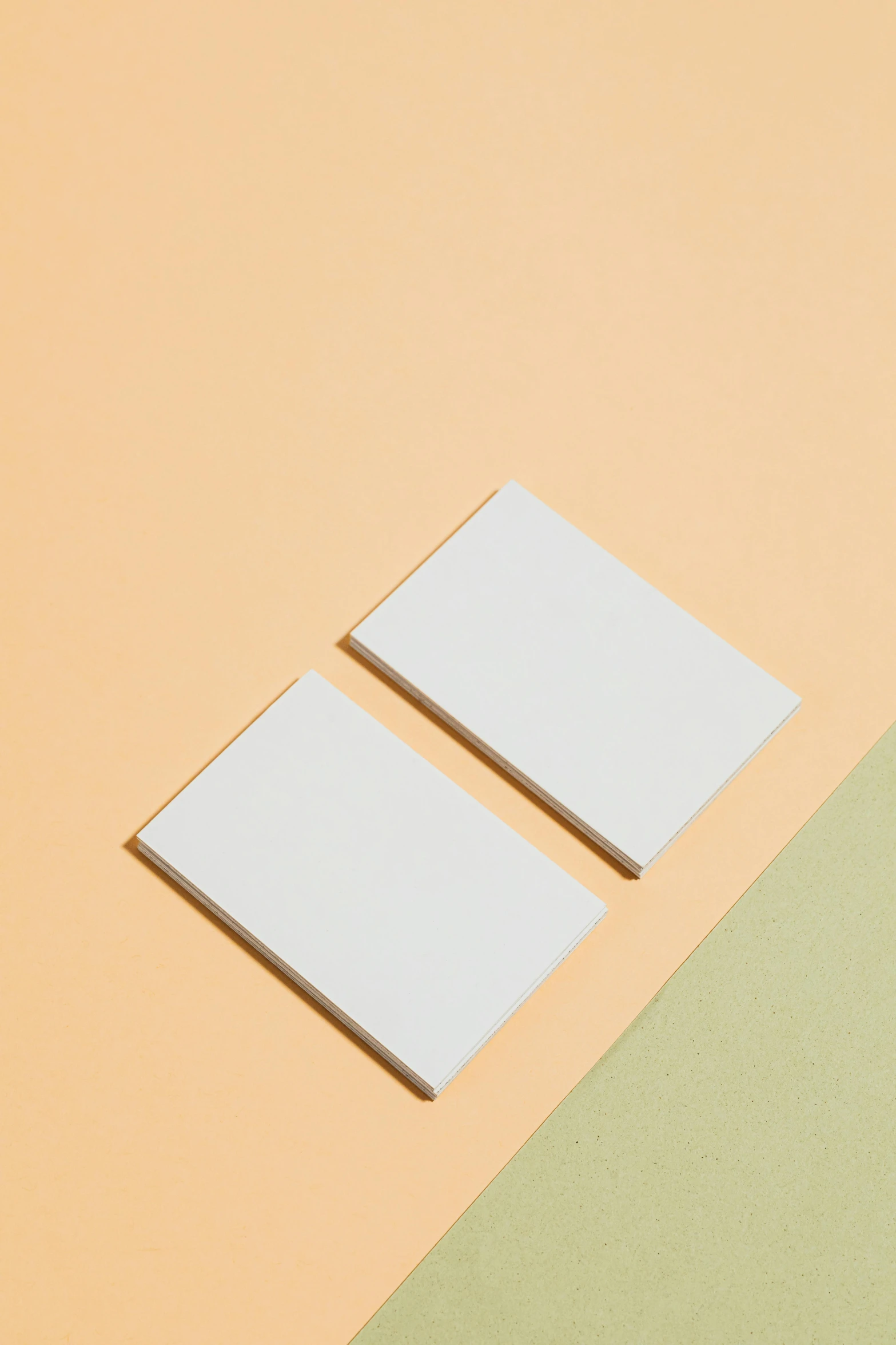 a couple of pieces of paper sitting on top of a table, postminimalism, solid color backdrop, detailed product image, panel, cards