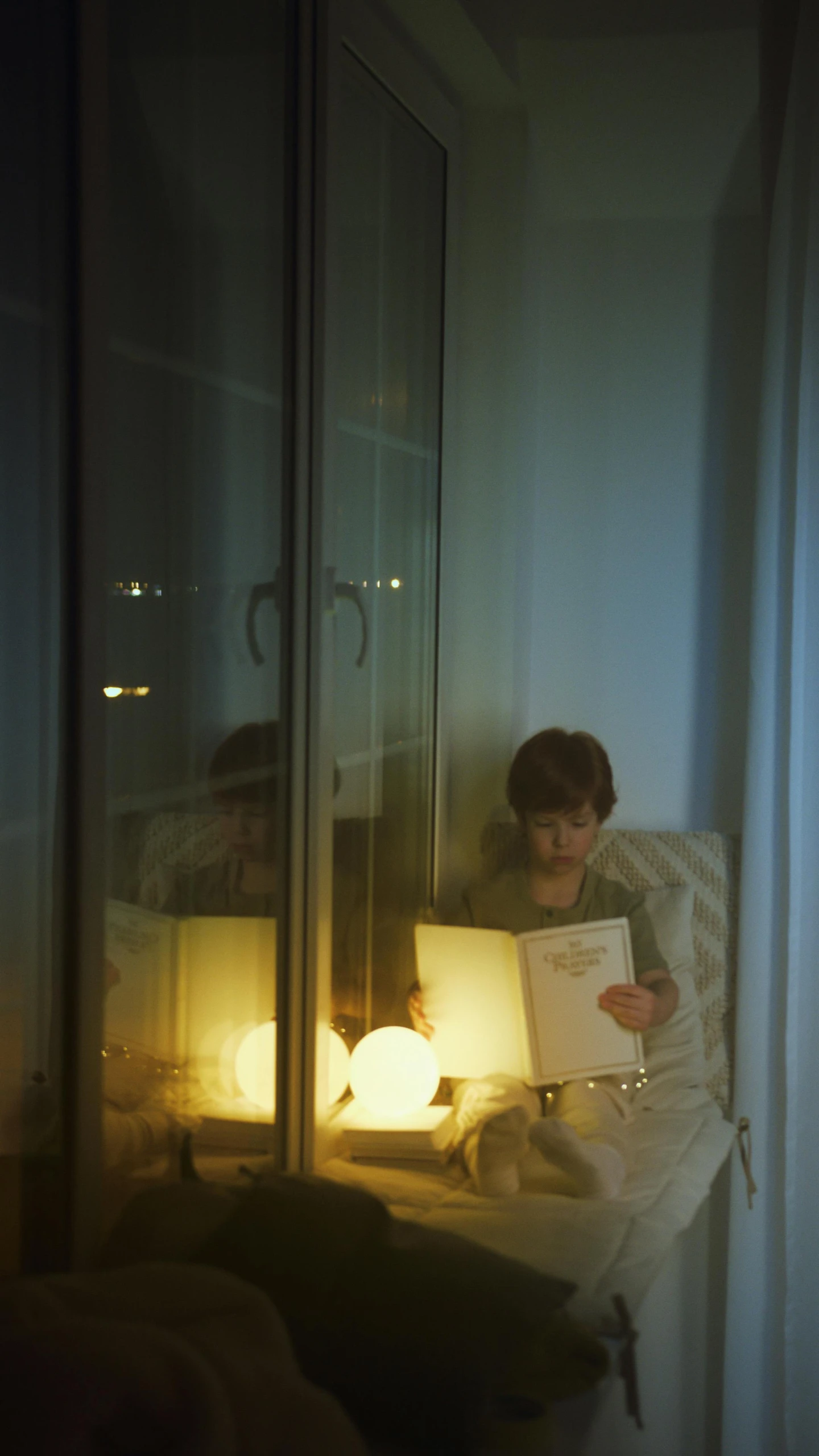 a person sitting in a chair reading a book, by Elsa Bleda, conceptual art, light over boy, with paper lanterns, studyng in bedroom, cinematic shot ar 9:16 -n 6 -g