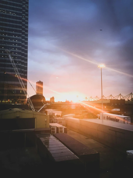 a train traveling down train tracks next to tall buildings, a picture, pexels contest winner, happening, epic sunrise, in future airport rooftop, photo taken from a boat, melbourne