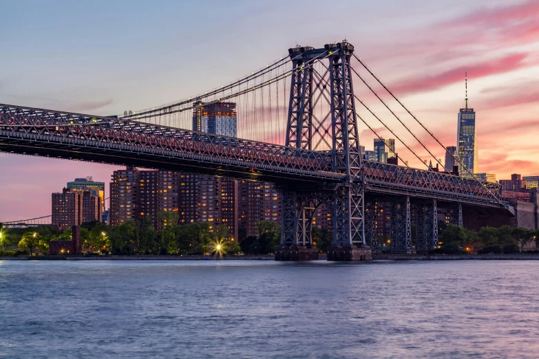 a bridge over a body of water with a city in the background, unsplash contest winner, hudson river school, pink golden hour, slide show, ad image