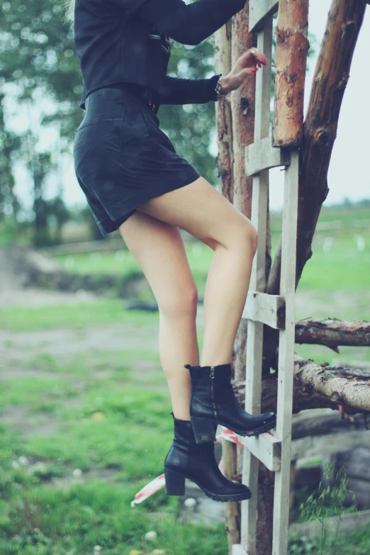 a woman in a black dress climbing a ladder, inspired by Elsa Bleda, unsplash, aestheticism, black leather boots, countryside, thighs thighs thighs thighs, 👰 🏇 ❌ 🍃