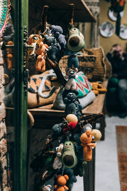 a room filled with lots of stuffed animals, a photo, by Jan Tengnagel, pexels contest winner, visual art, intricate african jewellery, black cat in a city made of yarn, shop front, knotted trees