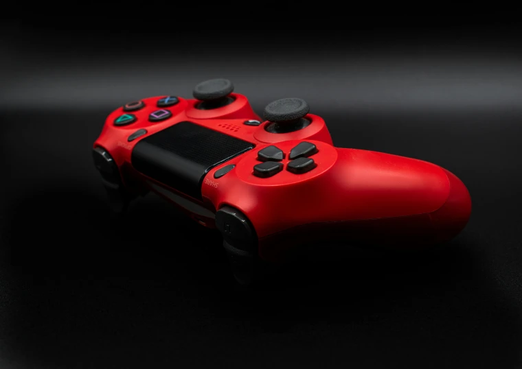 a red controller sitting on top of a black surface, pexels, ue4, playstation 4, instagram post, accurate and detailed