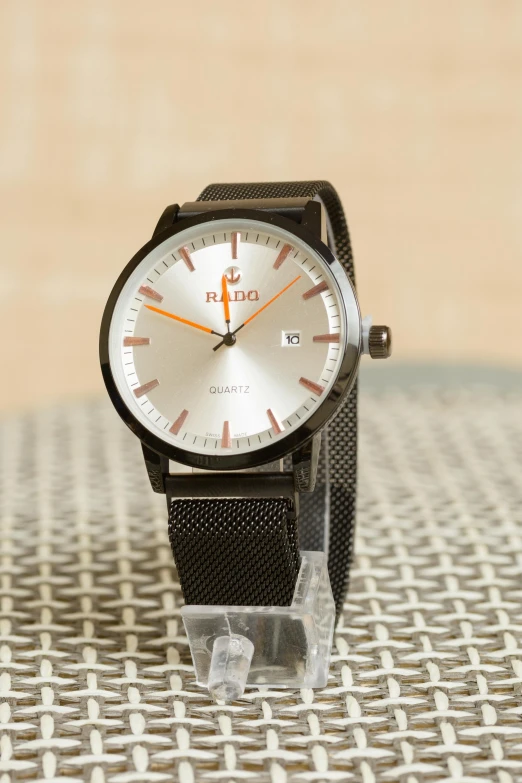 a close up of a watch on a table, by Jason Felix, promo image, baraka, orange grey white, demur