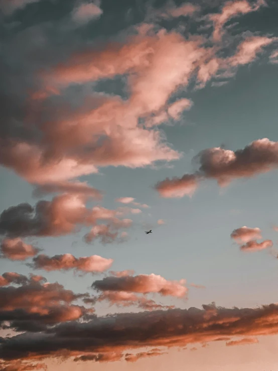 there is a plane that is flying in the sky, inspired by Elsa Bleda, pexels contest winner, aestheticism, light pink clouds, low quality photo, ☁🌪🌙👩🏾, atmospheric warm colorgrade