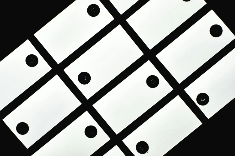 a bunch of white tags sitting on top of a table, an album cover, inspired by László Moholy-Nagy, unsplash, op art, black dots, office ceiling panels, ffffound, mid closeup