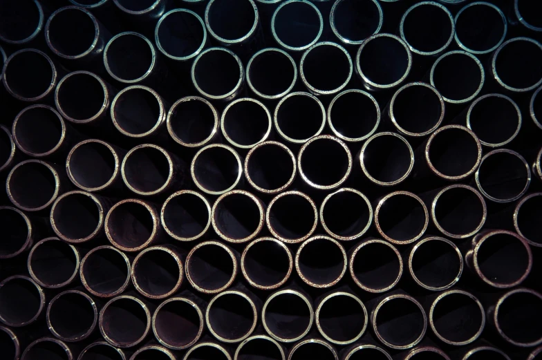 a bunch of metal pipes stacked on top of each other, by Carey Morris, unsplash, op art, high angle close up shot, multiple stories, tubing, many holes