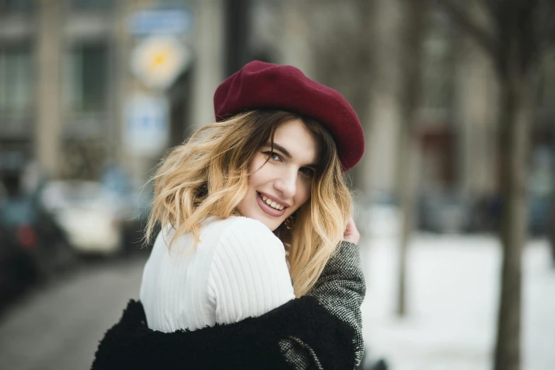 a close up of a person wearing a hat, in the winter, wearing a french beret, perfect smile, blonde and auburn two toned hair