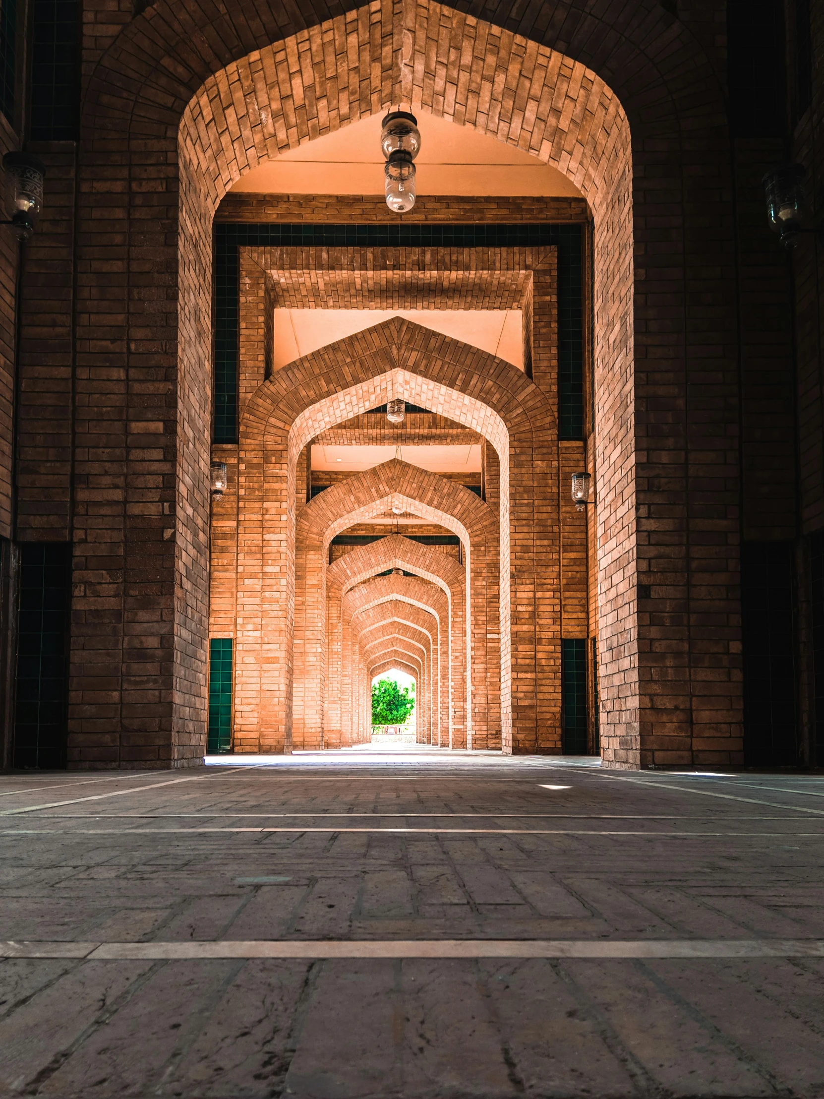 a green fire hydrant sitting on top of a brick floor, a picture, inspired by Kamāl ud-Dīn Behzād, unsplash contest winner, renaissance, tall arched stone doorways, cybermosque interior, symmetrical 4k, louis kahn