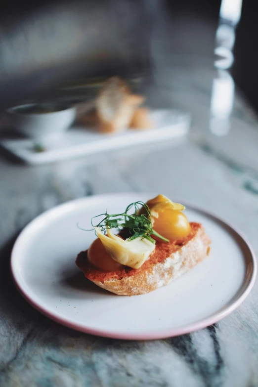 a close up of a plate of food on a table, inspired by Modest Urgell, unsplash, toast, square, potato skin, madrid