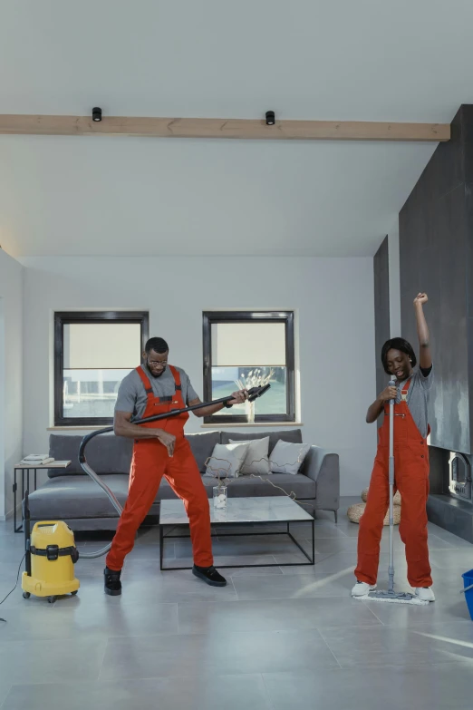 a couple of people that are standing in a room, an album cover, inspired by Michael Gustavius Payne, pexels contest winner, arbeitsrat für kunst, wearing plumber uniform, performing a music video, sweeping, mkbhd