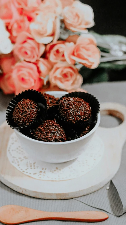 a bowl of chocolates sitting on top of a white plate, pexels contest winner, hurufiyya, flower, indoor setting, thumbnail, rice